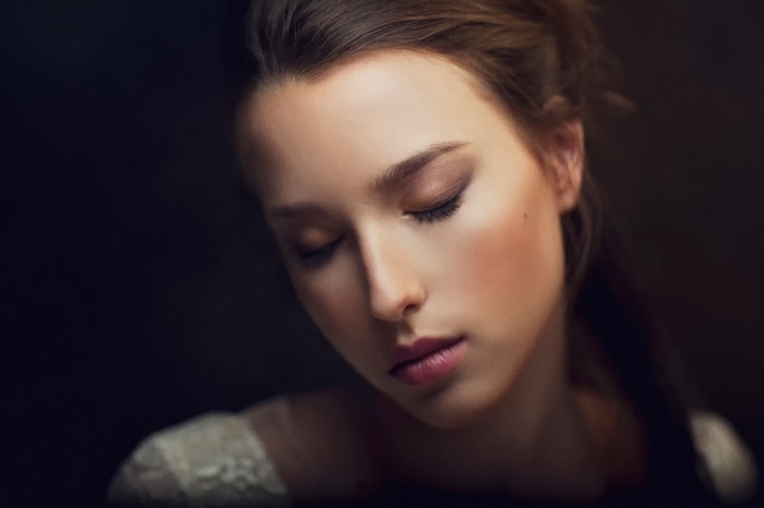 Close-up portrait of a young woman with eyes closed