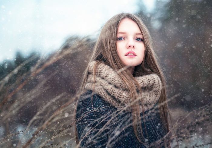 Woman with blue eyes and brunette hair in winter