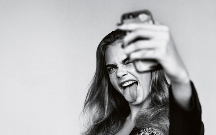 Cara Delevingne taking a selfie and sticking her tongue out