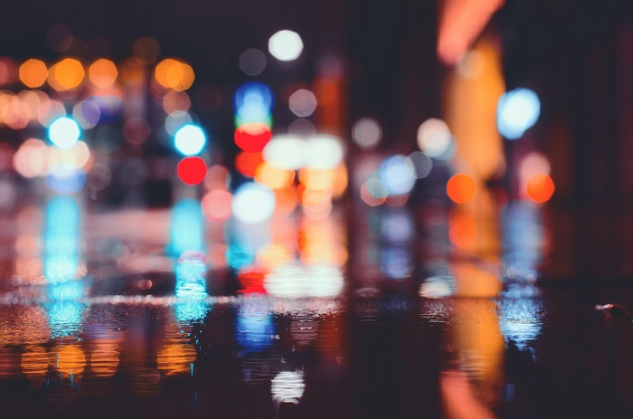Bokeh reflections of city lights on wet street