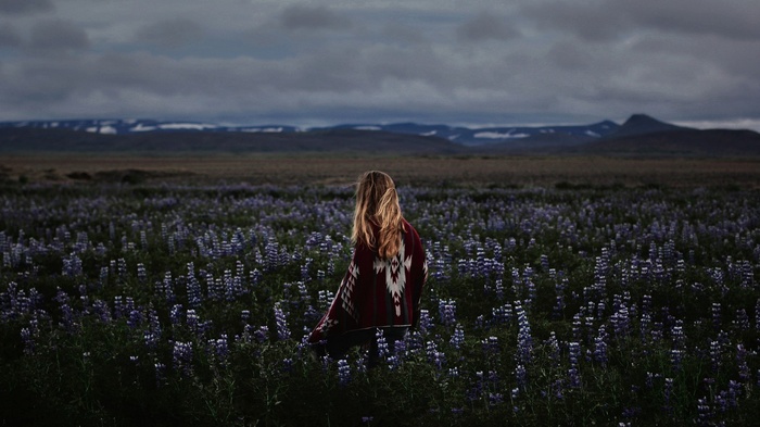 Woman with blonde hair in a field of purple flowers
