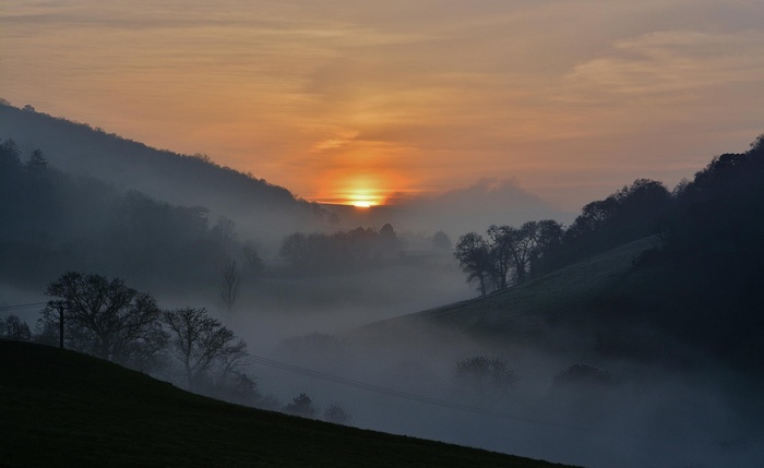 Misty valley at sunset in England