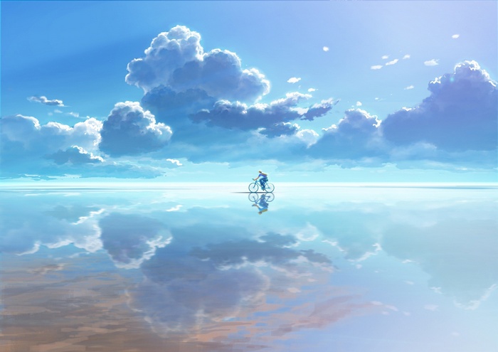 Person riding a bicycle on a reflective surface with clouds