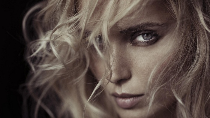 Close-up portrait of a blonde woman with blue eyes