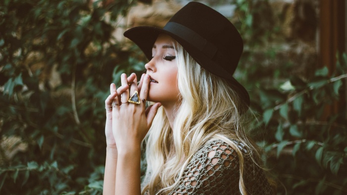 Woman wearing a black hat and rings