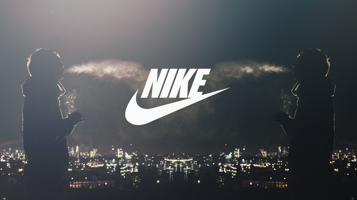 Nike logo with two people smoking at night