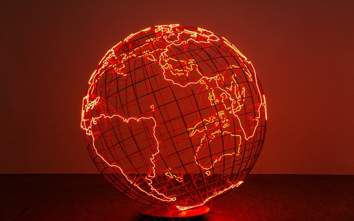 Wireframe globe with neon continents on a dark background