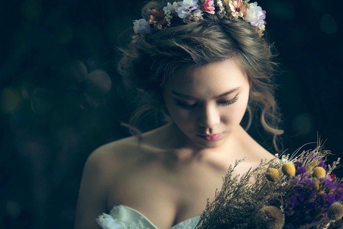 Asian woman with flower crown and bouquet
