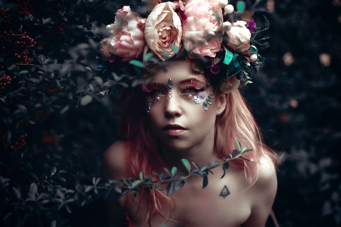 Woman with flower crown and face gems