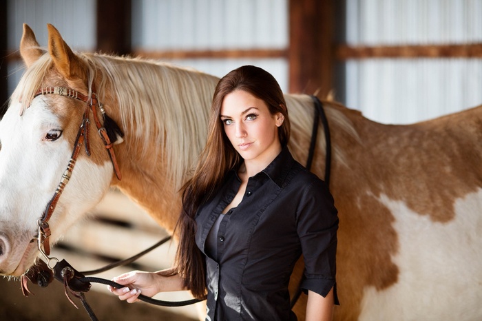 Woman in black shirt with a horse