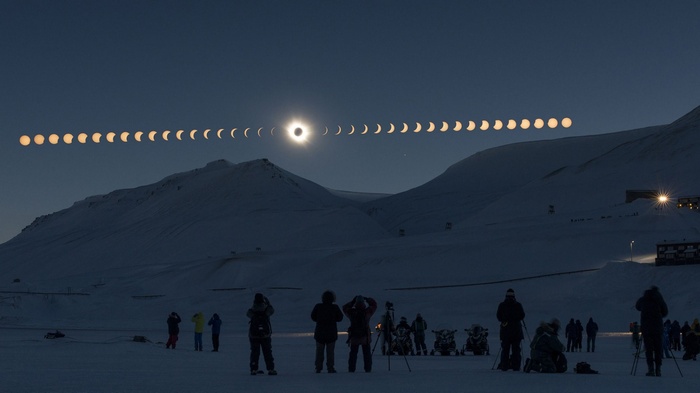 Time-lapse of a solar eclipse over snowy mountains