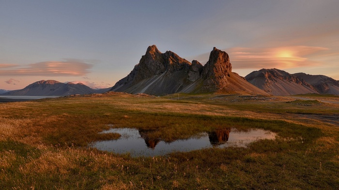 Mountain landscape with a pond at sunset