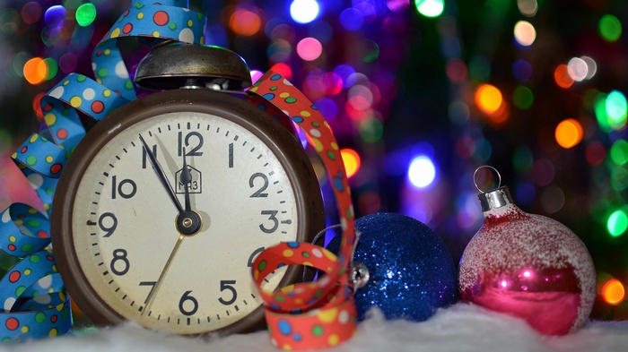 Alarm clock with Christmas ornaments and bokeh lights