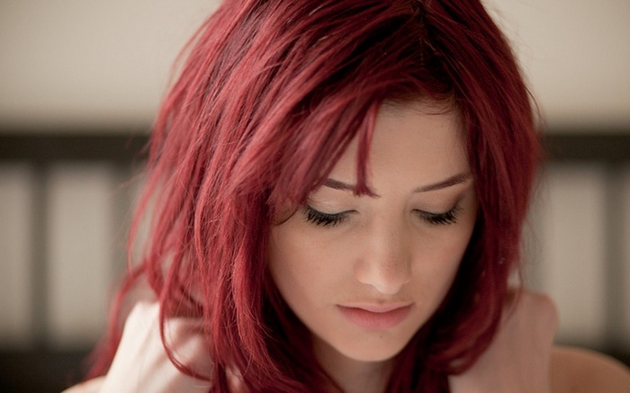 Susan Coffey with red hair looking down