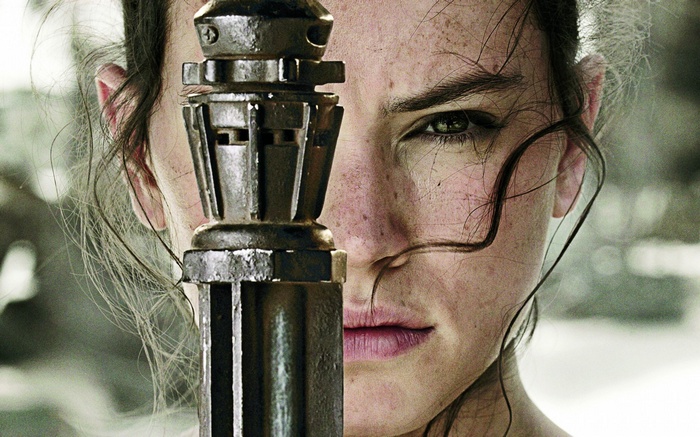 Rey from Star Wars holding a lightsaber