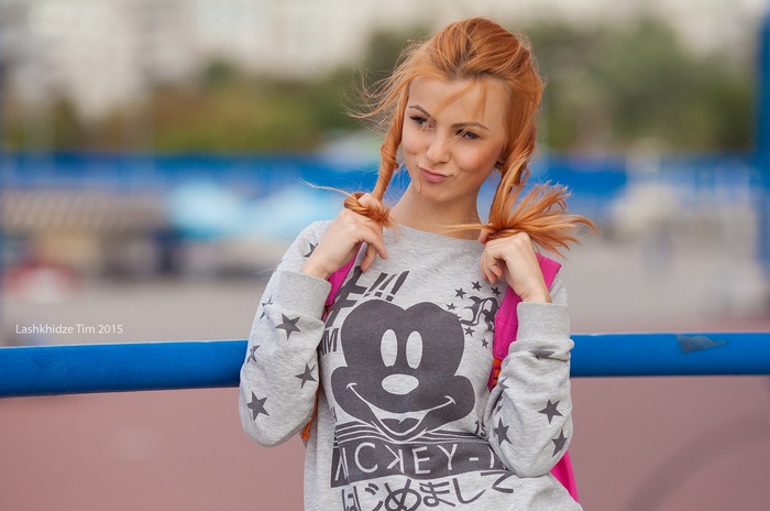Woman with pigtails wearing Mickey Mouse sweatshirt