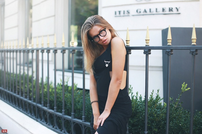 Woman with glasses in a black dress