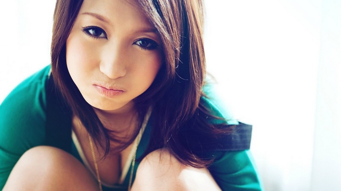 Asian woman pouting and looking at viewer