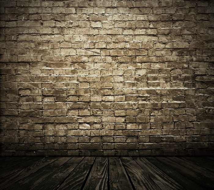 A textured brick wall and wooden floor
