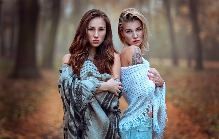 Two women wrapped in blankets outdoors