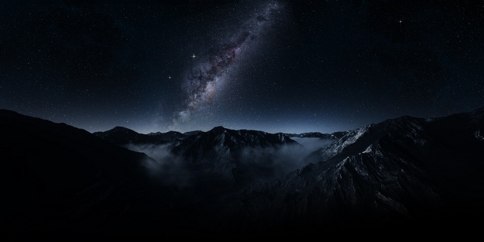 Milky Way over misty mountains at night