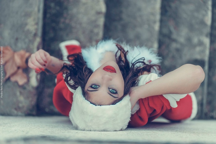 Ana de Carvalho in a Santa costume lying down