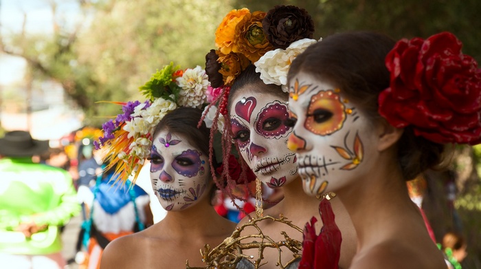 Women with Dia de los Muertos makeup and flower crowns