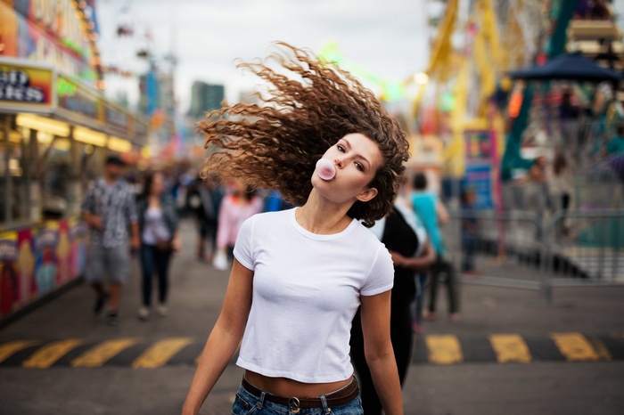 Woman blowing bubble gum at a carnival