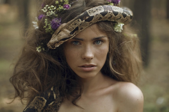 Woman with snake and flowers in her hair