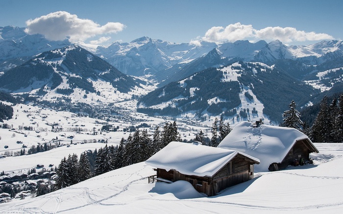 Snowy mountain village with wooden cabins