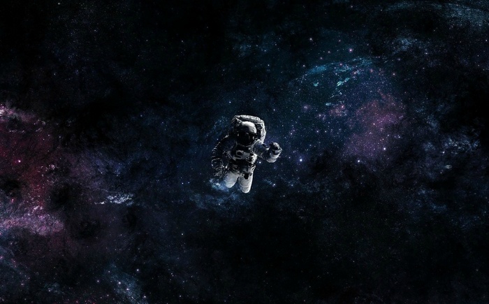 Astronaut floating in a colorful nebula