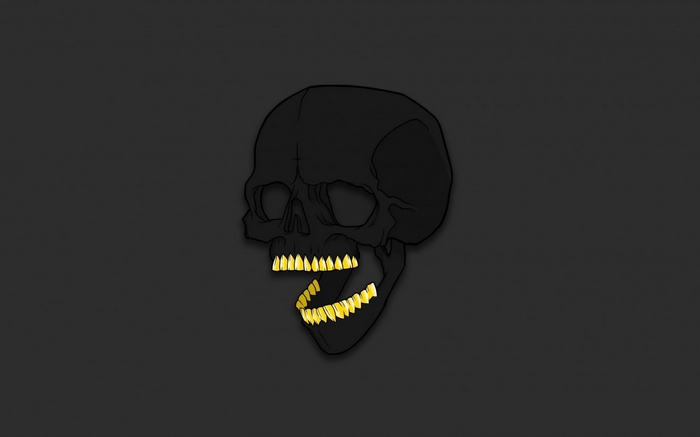 Black skull with gold teeth on a dark background