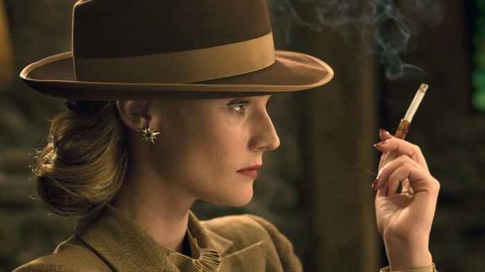 Diane Kruger smoking a cigarette in a hat