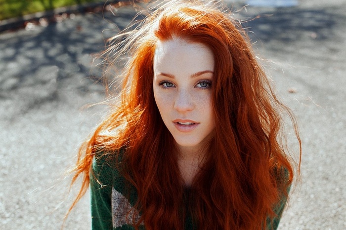 Redhead woman with freckles and blue eyes