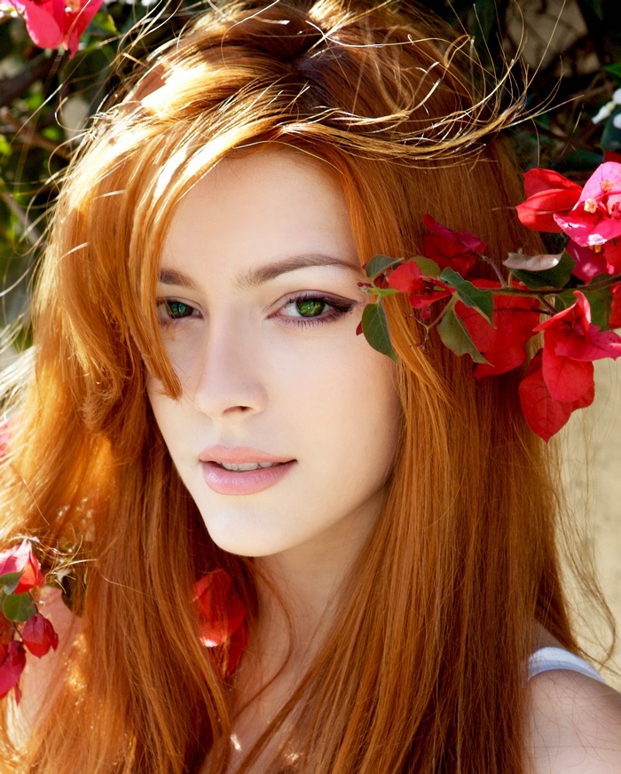 Elena Satine with red hair and flowers