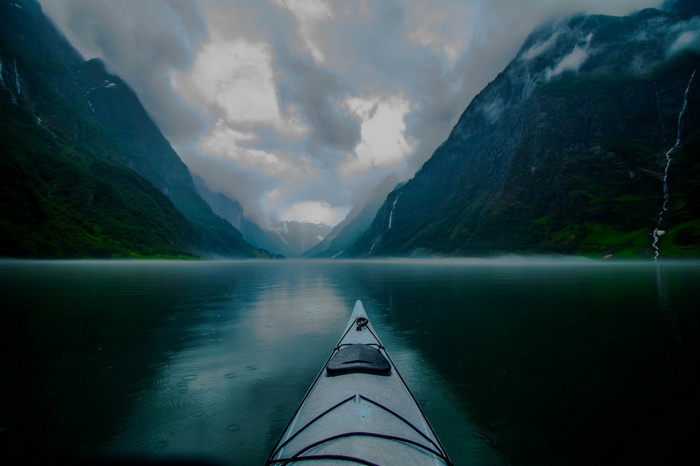 Kayaking through a misty fjord in Norway