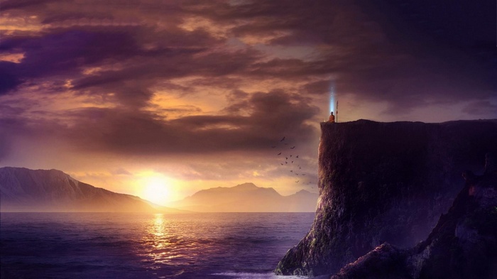 Monk meditating on a cliff at sunset over the sea