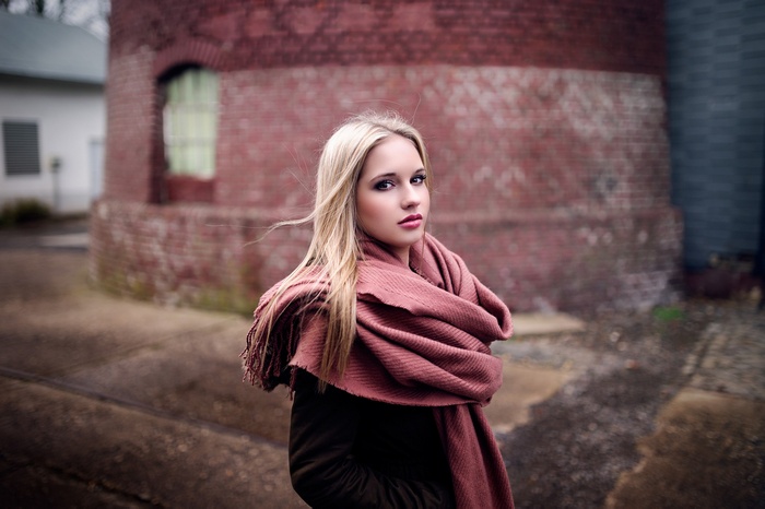 Woman with blonde hair and scarf outdoors