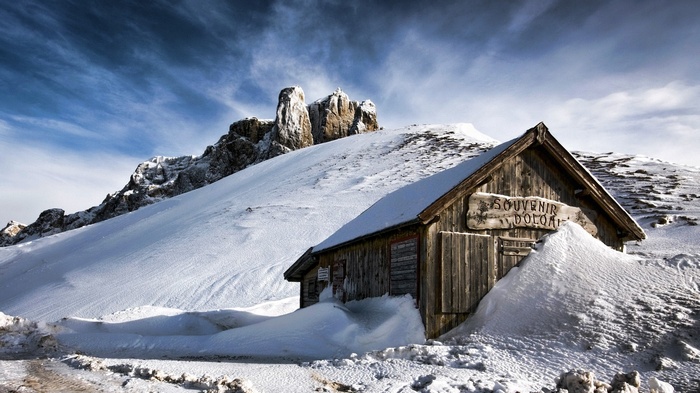 Wooden souvenir shop in the snowy Dolomites mountains