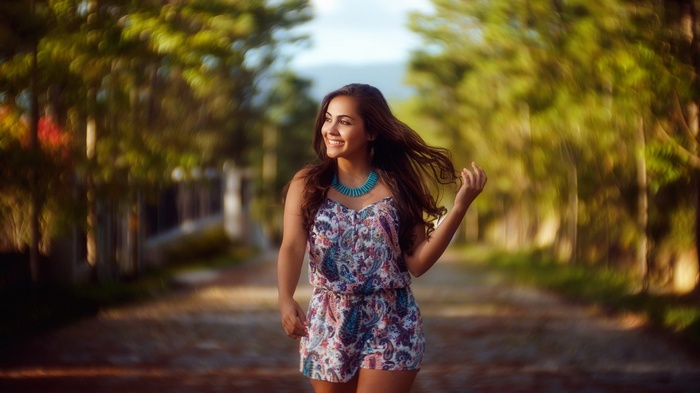 Woman in a patterned romper walking outdoors