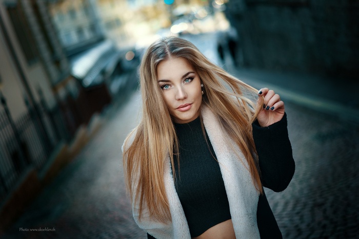 Portrait of a blonde woman with blue eyes outdoors
