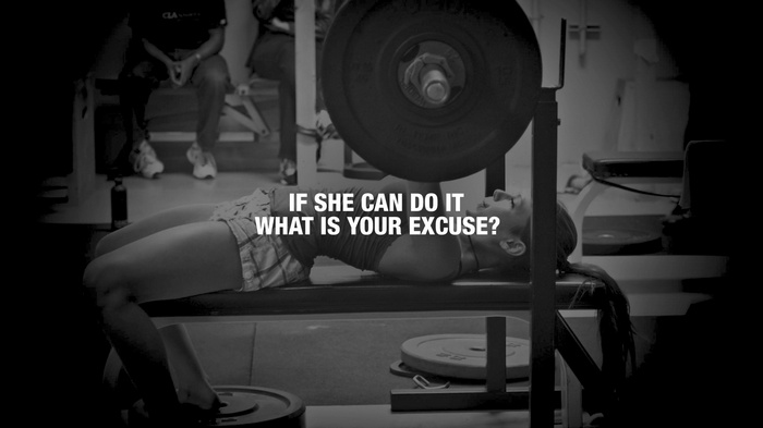 Woman bench pressing with motivational quote
