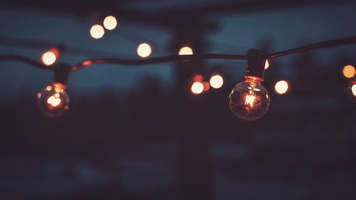 String of glowing lightbulbs at night
