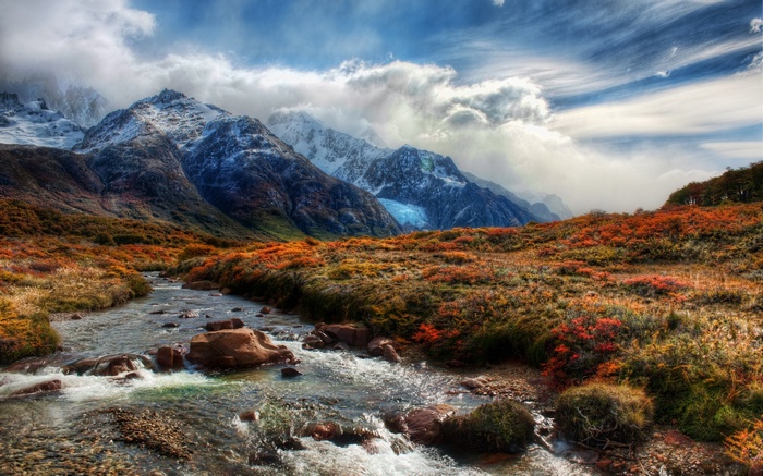 Mountain landscape with a stream and autumn foliage