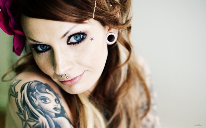 Woman with tattoos and piercings