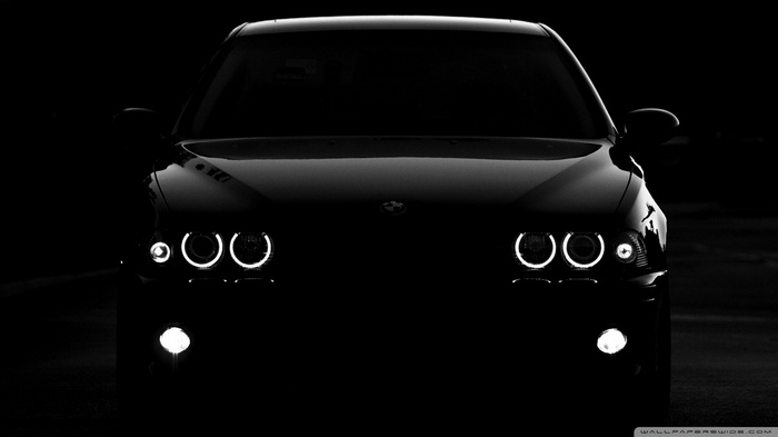 Black BMW M5 E39 with illuminated headlights