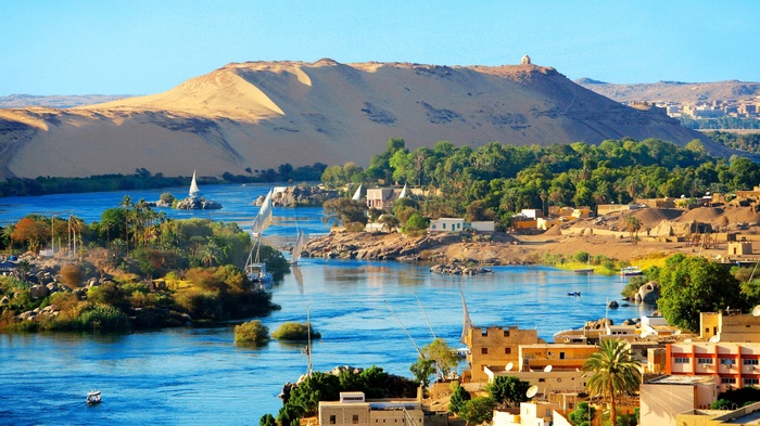 Nile River landscape with feluccas and desert hills