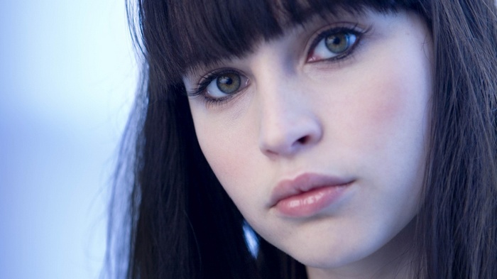 Felicity Jones with dark hair and green eyes