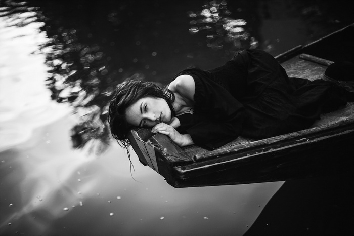 Monochrome photo of a woman in a boat