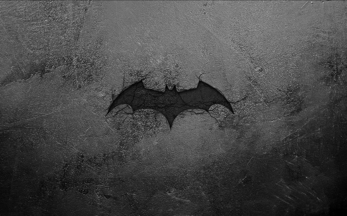 Batman Logo Cracked on Textured Surface
